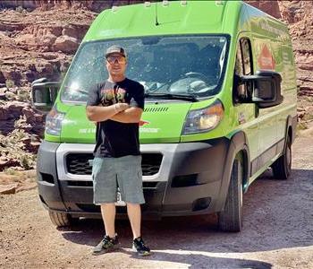 Steve standing in front of a green van. 